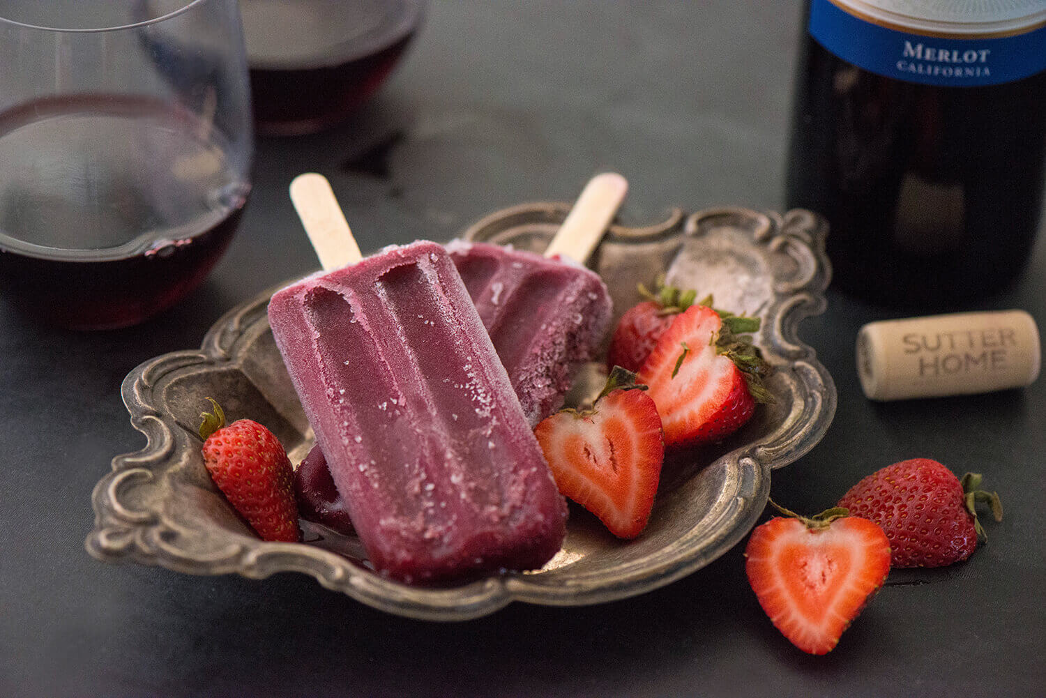 A plate of ice cream and strawberries on the table.