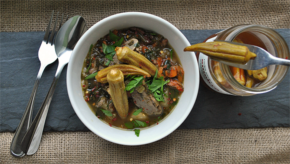 A bowl of soup with vegetables and meat.