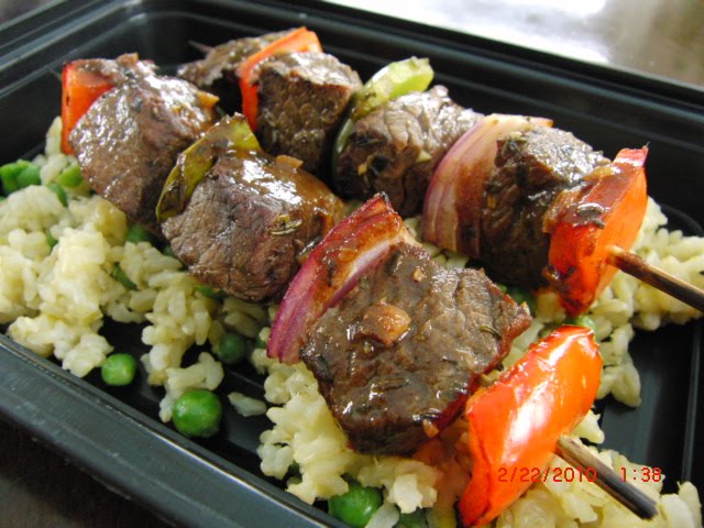 A tray of food with rice and meat.