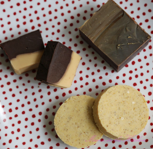 A close up of two cookies and one chocolate bar