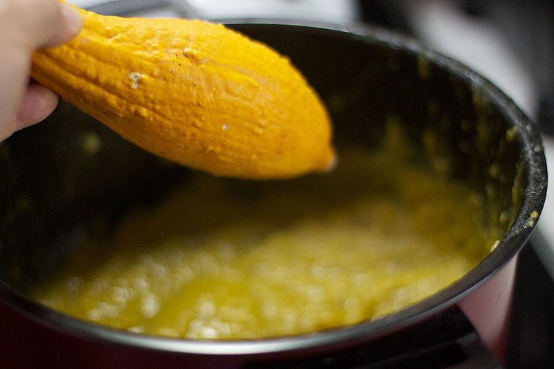 A lemon is being stirred in a pot.