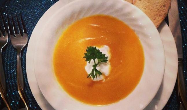 A white plate topped with soup and garnish.