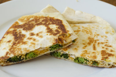 A close up of two quesadillas on a plate