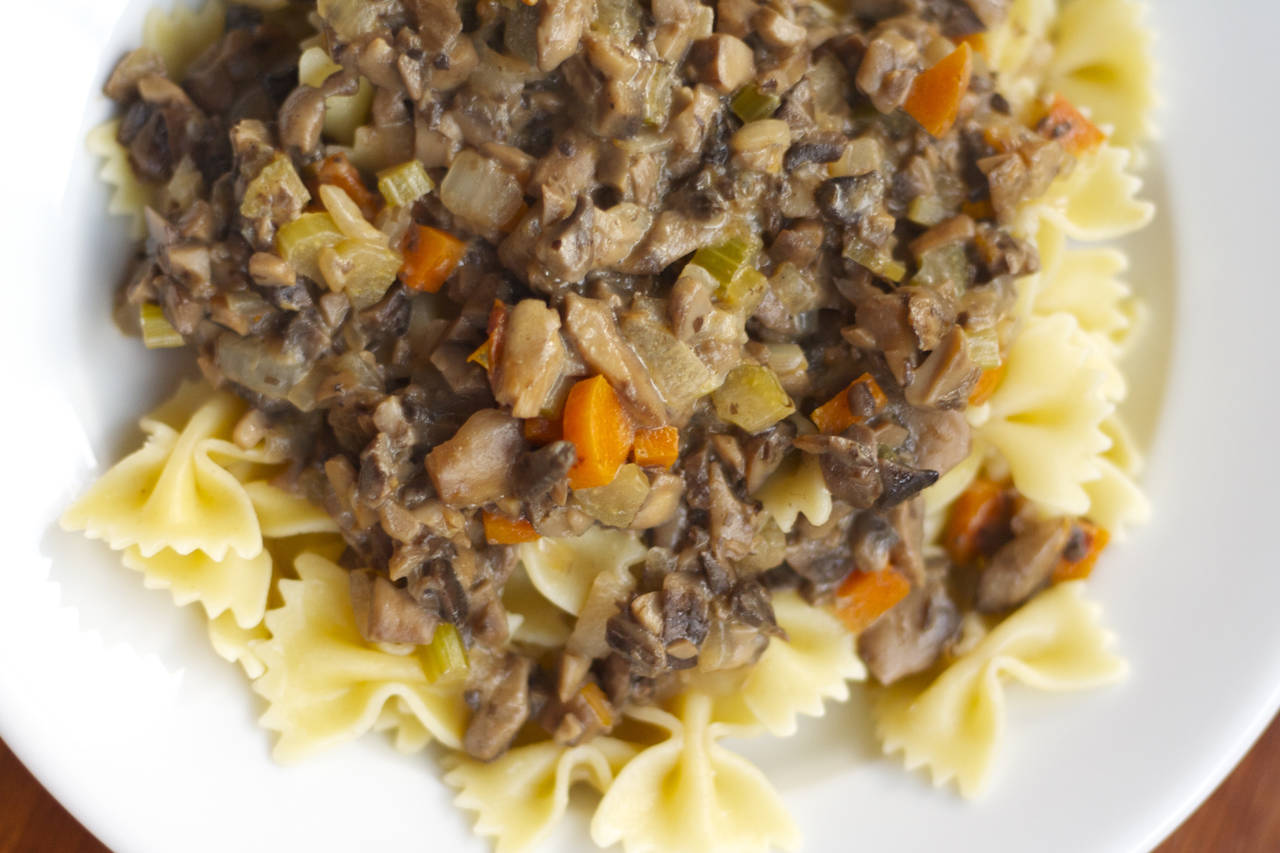 A close up of pasta with meat and vegetables