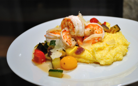 A plate of food with shrimp and vegetables on it.