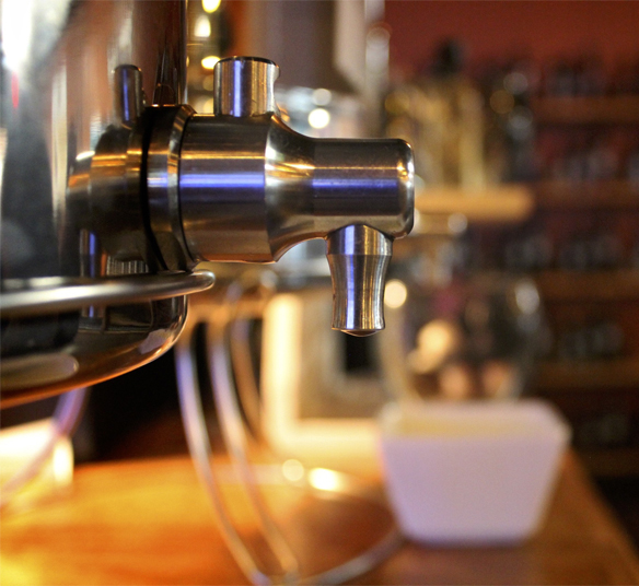 A close up of the handle on an espresso machine.